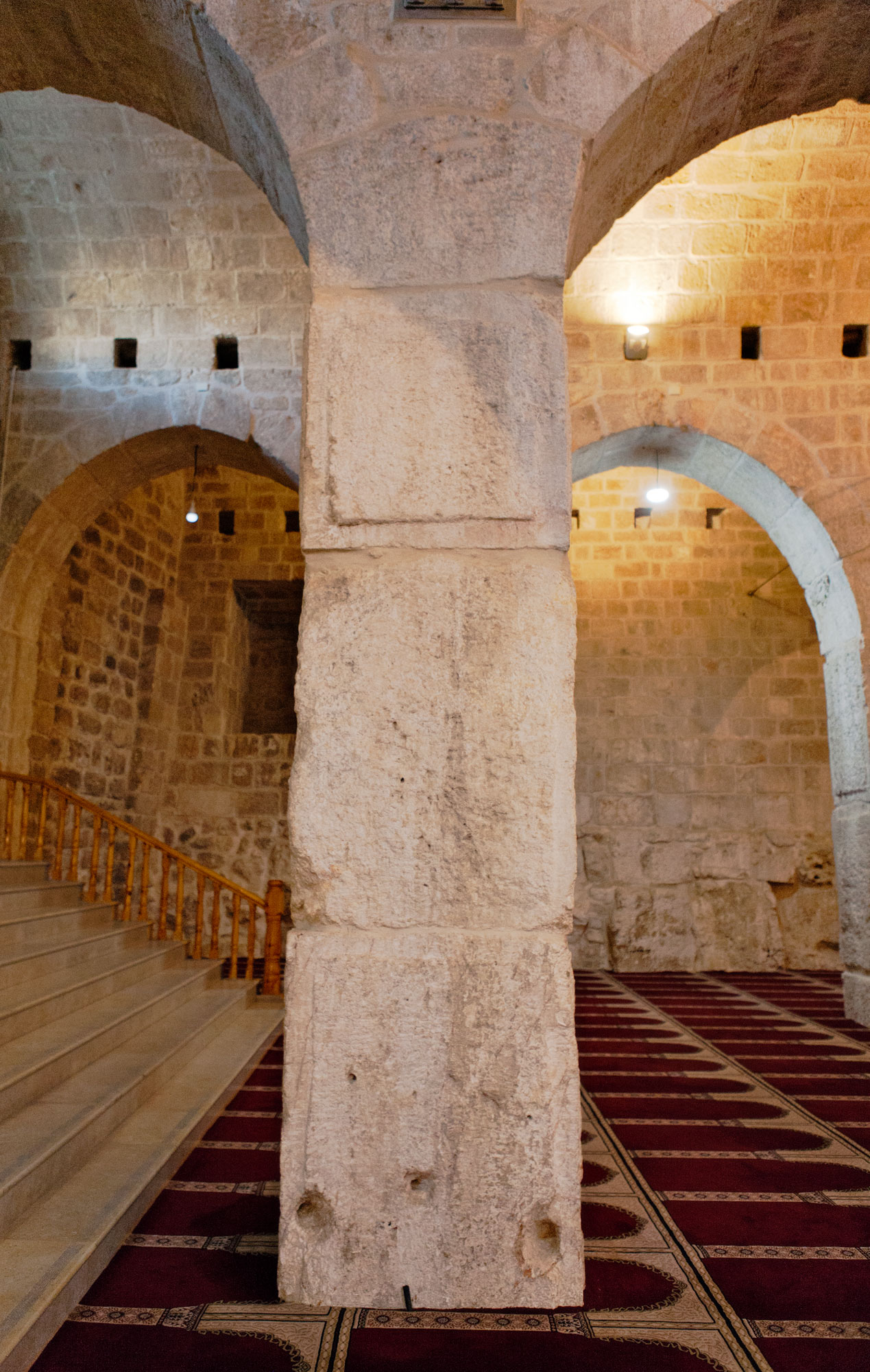 Putlog holes above and piercings on column bases below, the latter to tether the halters of Crusader horses. View east.