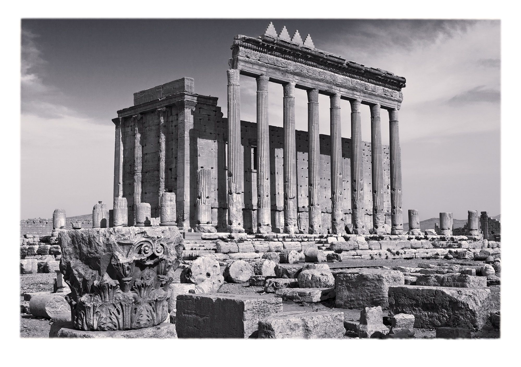 The shurafat, or stepped merlons, such as those on the colonnaded portico became a hallmark of Umayyad  architectural projects in the 7th- and 8th-centuries CE.  Note the Ionic capitals in the engaged columns of the narrow (southern) face of the cella, whereas most of the other capitals and entablature  are Corinthian, such as the one in the foreground with acanthus and volutes.