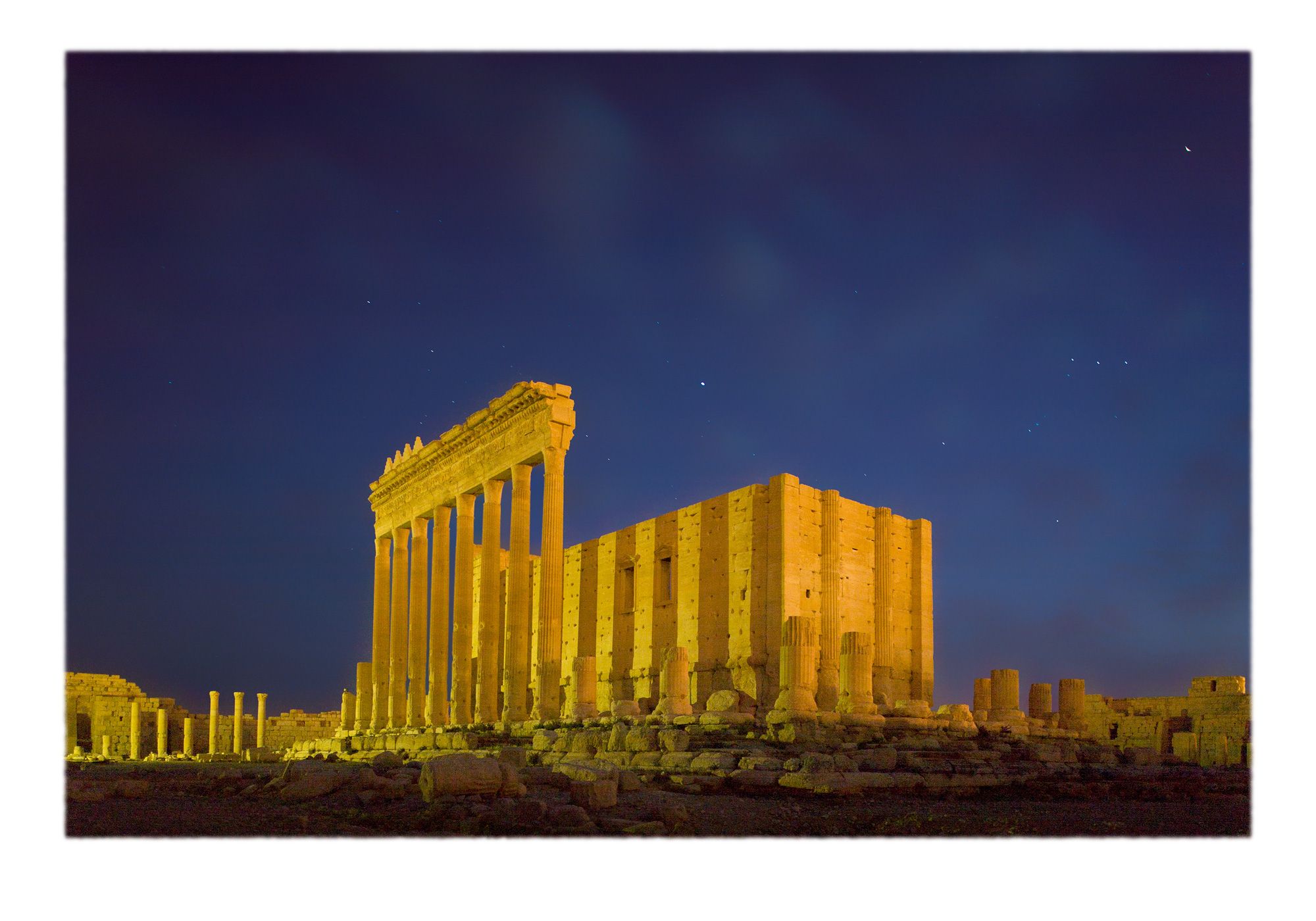Nightime view of the constellation Orion and the lost archaeological ruins of the monumental pagan Temple of Baal in the classical style. The raised Naos in the proximate center of the elevated tememos was consecrated  in 32 CE to the Semitic deity Baal who was assimilated with the Mesopotamian god Bel-Marduk, both of whom presided over the movement of the stars.  Palmyra aka Tadmur, Syria.