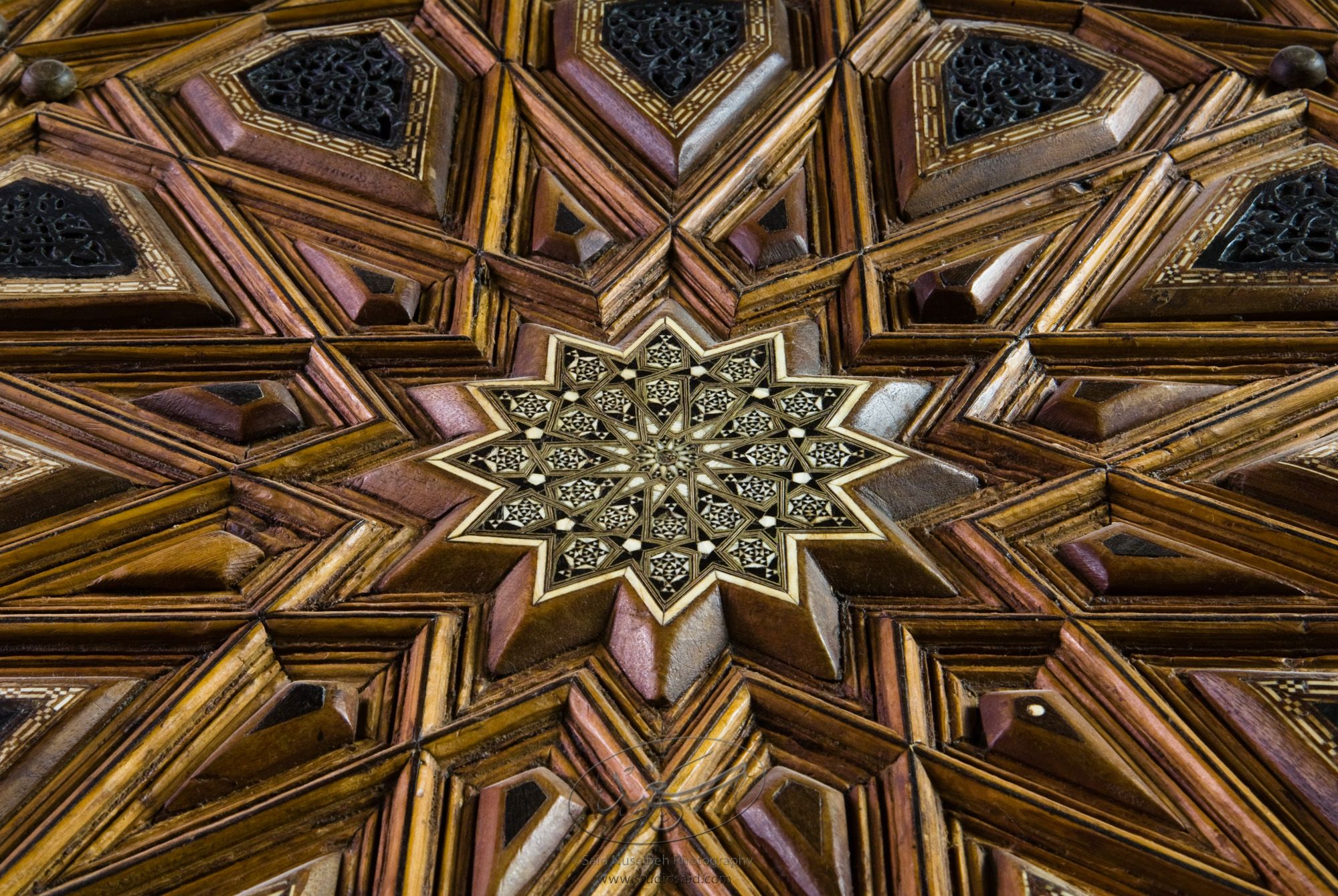 "Radiating Dodecagon. Minbar, Carved Woodwork and Inlay Detail"The late-13th / early-14th c. Mamluk minbar, or pulpit, of Sultan al-Nasir Muhammad, the ninth Mamluk Sultan from Cairo and son of Qalawun. The minbar was located in the Umayyad Mosque in Aleppo, Haleb, prior to its damage and disappearance in May 2013.