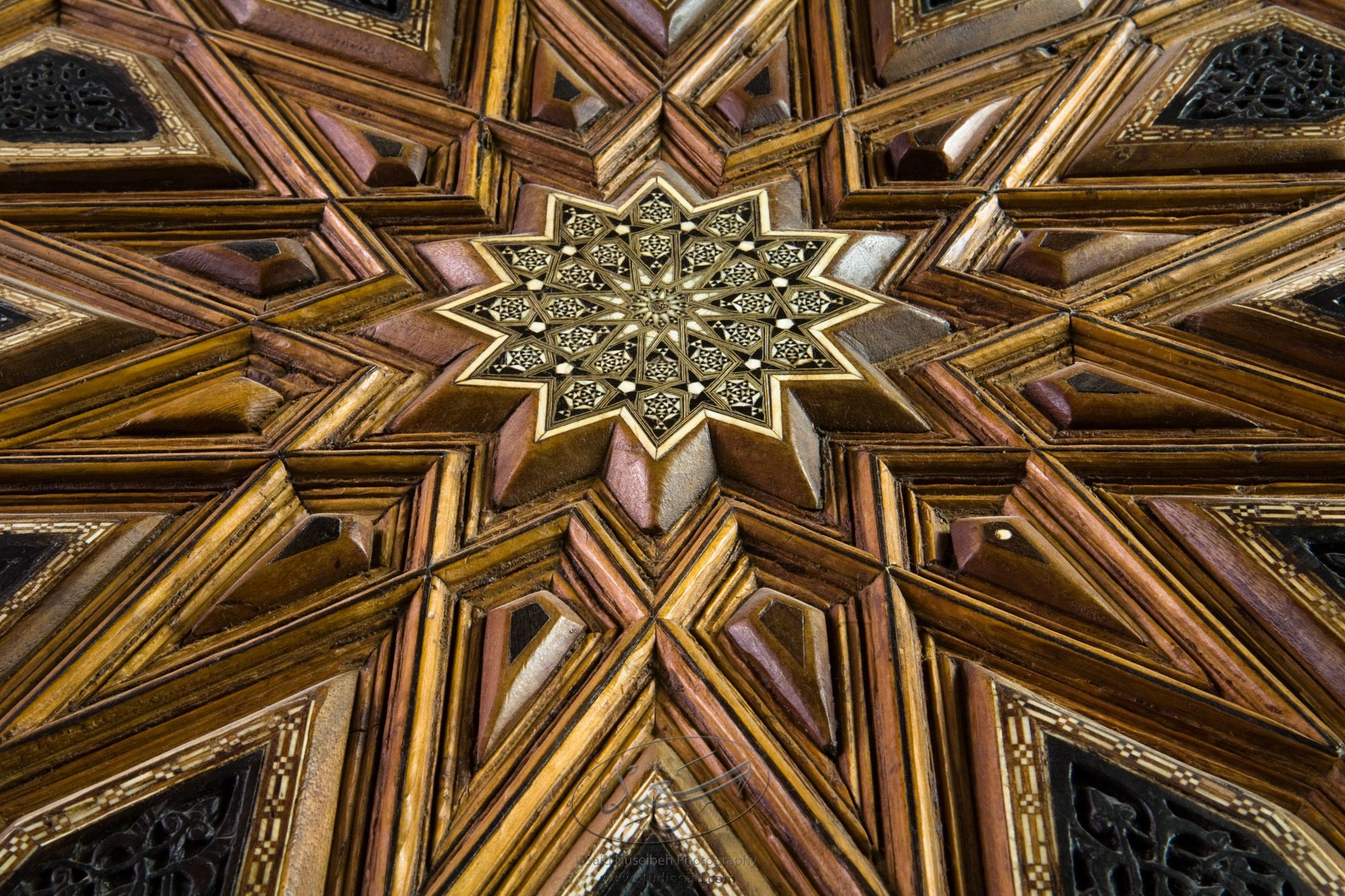 "Twelve-sided stars. Minbar, Carved Woodwork and Inlay Detail"The late-13th / early-14th c. Mamluk minbar, or pulpit, of Sultan al-Nasir Muhammad, the ninth Mamluk Sultan from Cairo and son of Qalawun. The minbar was located in the Umayyad Mosque in Aleppo, Haleb, prior to its damage and disappearance in May 2013.