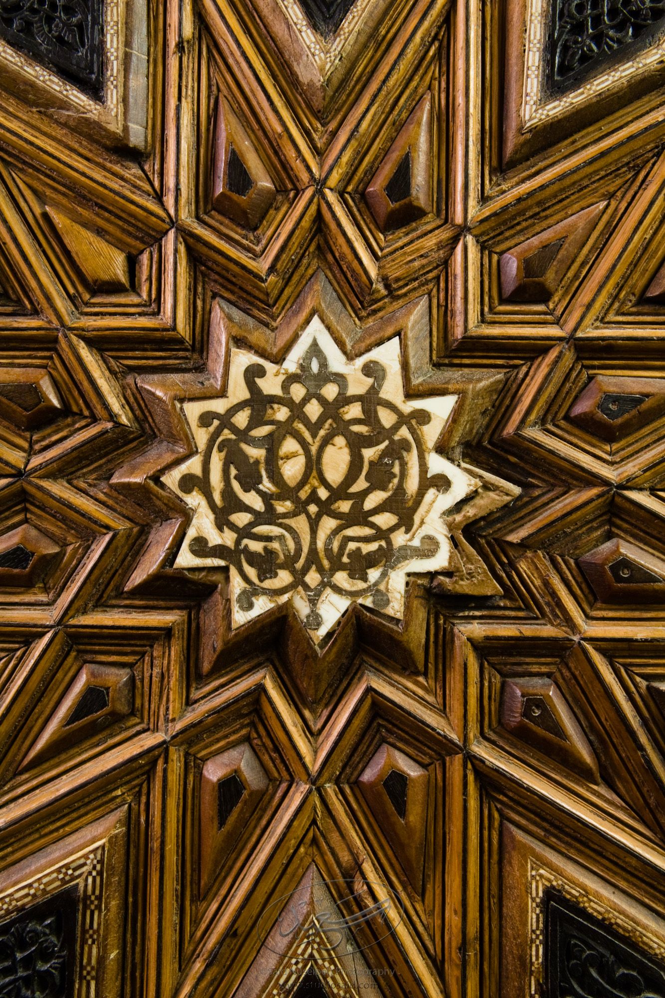 "Symmetrical Floral Interlace inside Dodecagons. Minbar, Carved Woodwork and Inlay Detail"The late-13th / early-14th c. Mamluk minbar, or pulpit, of Sultan al-Nasir Muhammad, the ninth Mamluk Sultan from Cairo and son of Qalawun. The minbar was located in the Umayyad Mosque in Aleppo, Haleb, prior to its damage and disappearance in May 2013.