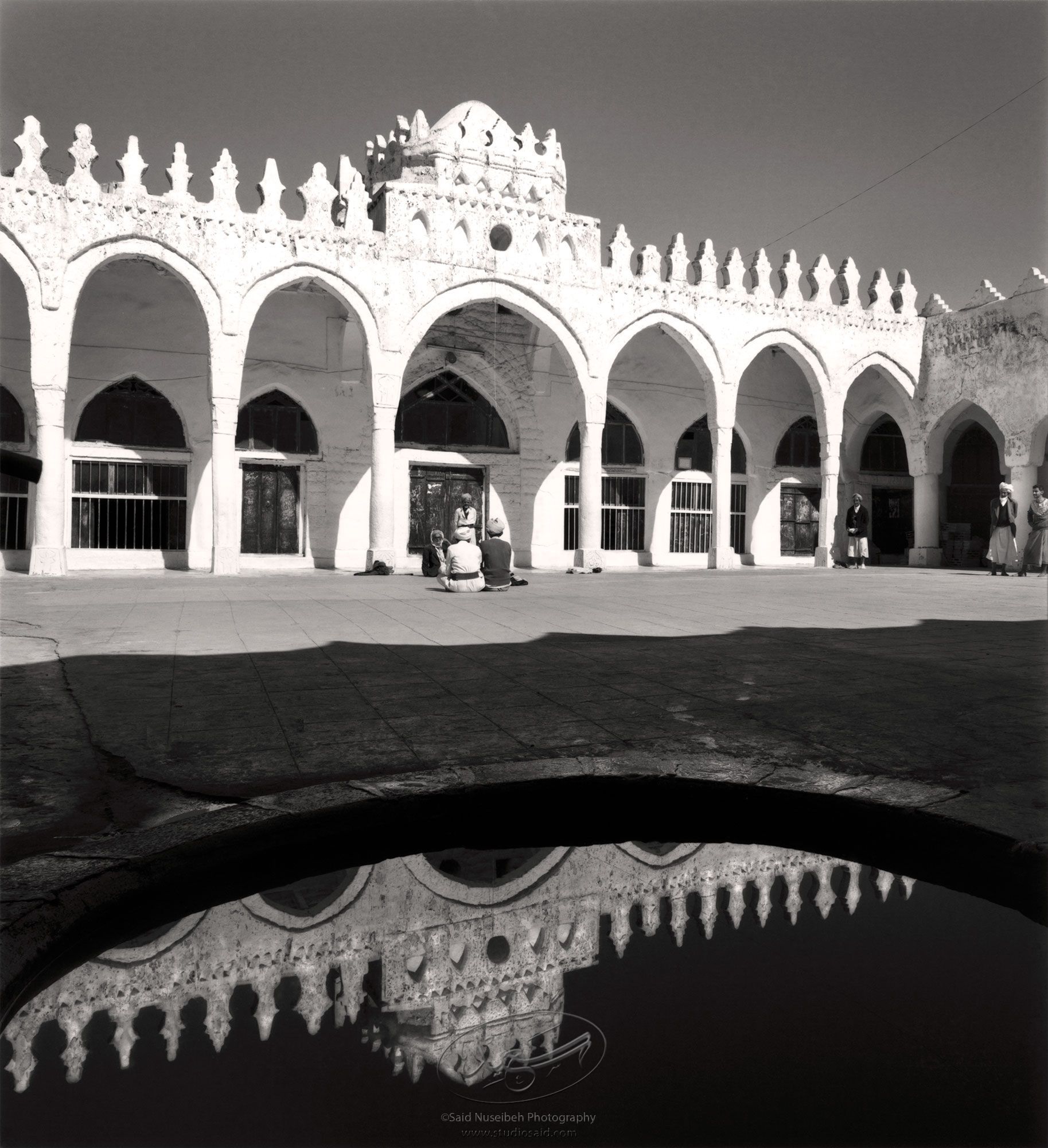 Shallow pool blocking access between rooms of <i>wudu'</i><br>and the mosque proper. Village mosque in Jiblah, Yemen